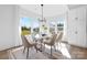 Elegant dining room bathed in natural light, featuring a glass table and seating for six at 908 Cypress Point Ln # 218, Monroe, NC 28112
