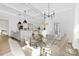 Bright dining area featuring a glass-top table, modern chandelier, and easy access to the kitchen at 908 Cypress Point Ln # 218, Monroe, NC 28112