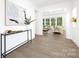 Inviting foyer with modern console table, view into a bright living room with large windows at 908 Cypress Point Ln # 218, Monroe, NC 28112