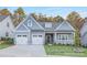 Charming craftsman-style home with a two-car garage and inviting front porch, nestled amongst mature trees at 908 Cypress Point Ln # 218, Monroe, NC 28112