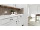 Modern kitchen with white cabinets, stone backsplash, quartz countertops, and convenient counter space at 908 Cypress Point Ln # 218, Monroe, NC 28112