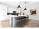 Modern kitchen featuring a large island with seating, stainless steel appliances, and stylish pendant lights at 908 Cypress Point Ln # 218, Monroe, NC 28112