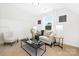 Well-lit living room with a cozy sofa, natural light, and minimalist decor at 908 Cypress Point Ln # 218, Monroe, NC 28112