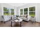 Cozy living room with large windows offering scenic views, neutral furniture, and ample natural light at 908 Cypress Point Ln # 218, Monroe, NC 28112