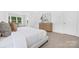Bright main bedroom featuring a large window, dresser, and a comfortable bed at 908 Cypress Point Ln # 218, Monroe, NC 28112