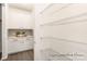 Well-organized pantry with wire shelving, storage cabinets, and countertop space for kitchen essentials at 908 Cypress Point Ln # 218, Monroe, NC 28112