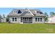 Charming home featuring a screened porch, dormer windows, and well-maintained green lawn at 908 Cypress Point Ln # 218, Monroe, NC 28112