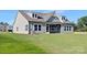 Beautiful rear exterior featuring a screened-in porch and a lush green lawn at 908 Cypress Point Ln # 218, Monroe, NC 28112