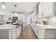 Well-lit white kitchen has stainless steel appliances, light countertops and backsplash, and an island sink at 920 Exeter Dr, Sherrills Ford, NC 28673