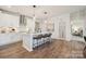 Well-lit kitchen boasts an island with seating, stainless steel appliances, and access to the laundry room at 920 Exeter Dr, Sherrills Ford, NC 28673