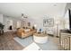 Inviting living room with a leather sofa, light-colored walls, and a modern ceiling fan, perfect for relaxation at 920 Exeter Dr, Sherrills Ford, NC 28673