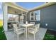 Charming outdoor patio featuring a dining table with white chairs, perfect for enjoying meals outdoors at 920 Exeter Dr, Sherrills Ford, NC 28673