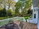 Wooden back deck featuring outdoor furniture overlooking a lush, green backyard at 9508 Hayenridge Ct, Huntersville, NC 28078