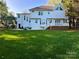 Spacious backyard featuring a patio, wooden deck, and lush green lawn at 9508 Hayenridge Ct, Huntersville, NC 28078