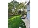 Beautiful backyard with a stone patio, fire pit, manicured lawn, and mature trees at 9508 Hayenridge Ct, Huntersville, NC 28078