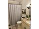 Cozy bathroom featuring granite counters, patterned shower curtain, and neutral paint at 9508 Hayenridge Ct, Huntersville, NC 28078