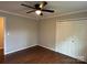 Bedroom featuring hardwood floors, ceiling fan, and double door closet at 9508 Hayenridge Ct, Huntersville, NC 28078