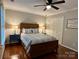 Comfortable bedroom with hardwood floors, a ceiling fan, and a pair of bedside tables with lamps on both sides of the bed at 9508 Hayenridge Ct, Huntersville, NC 28078