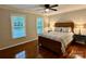 Cozy bedroom with hardwood floors, a ceiling fan, and two large windows that fill the room with an abundance of natural light at 9508 Hayenridge Ct, Huntersville, NC 28078