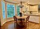 Charming breakfast nook with a round table, cushioned chairs, and a view of the backyard at 9508 Hayenridge Ct, Huntersville, NC 28078