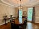 Spacious dining room with hardwood floors, modern chandelier, and large windows offer ample natural light at 9508 Hayenridge Ct, Huntersville, NC 28078
