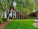 Elegant brick home with manicured front lawn and mature landscaping at 9508 Hayenridge Ct, Huntersville, NC 28078