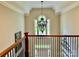 Foyer showcasing a decorative chandelier, staircase, and views through a large window at 9508 Hayenridge Ct, Huntersville, NC 28078