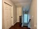Hallway featuring hardwood floors, a staircase, and a hanging light fixture at 9508 Hayenridge Ct, Huntersville, NC 28078