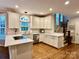 Bright, updated kitchen boasts white cabinetry, stainless appliances, and a large window at 9508 Hayenridge Ct, Huntersville, NC 28078