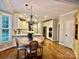 Open kitchen and breakfast nook featuring white cabinets, stainless appliances, and a chandelier at 9508 Hayenridge Ct, Huntersville, NC 28078
