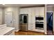 Kitchen featuring stainless steel appliances, white cabinets and countertops, with a nearby door at 9508 Hayenridge Ct, Huntersville, NC 28078