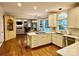 Gourmet kitchen open to the living room, featuring an island cooktop, stainless appliances, and eat-in kitchen at 9508 Hayenridge Ct, Huntersville, NC 28078