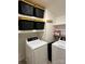 Laundry room featuring black storage bins, washer, dryer, and shelves at 9508 Hayenridge Ct, Huntersville, NC 28078