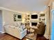 Cozy living room features a fireplace, built-in bookshelves, and neutral-toned furniture at 9508 Hayenridge Ct, Huntersville, NC 28078