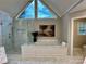 Bright main bathroom features a vaulted ceiling, statement windows, tiled floors, soaking tub, and frameless glass shower at 9508 Hayenridge Ct, Huntersville, NC 28078