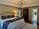 Relaxing main bedroom with tray ceiling, chandelier, hardwood floors, and an ensuite bathroom for ultimate privacy at 9508 Hayenridge Ct, Huntersville, NC 28078