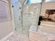 Stunning glass enclosed shower with subway tile and built-in shelving, located inside the elegant bathroom at 9508 Hayenridge Ct, Huntersville, NC 28078