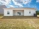Backyard with sliding glass doors opening to covered patio, and exterior HVAC unit at 105 Tanner Loop, Troutman, NC 28166