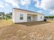 White two-story home with a covered patio and a spacious grassy yard at 105 Tanner Loop, Troutman, NC 28166