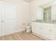 Bathroom with granite countertops, white cabinets, and luxury vinyl flooring at 105 Tanner Loop, Troutman, NC 28166