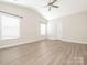 Spacious bedroom featuring vaulted ceilings, ceiling fan, and two large windows offering plenty of natural light at 105 Tanner Loop, Troutman, NC 28166