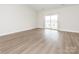 Spacious bedroom featuring luxury vinyl flooring, neutral paint, and a sliding glass door at 105 Tanner Loop, Troutman, NC 28166
