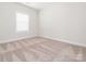 New carpet flooring, clean baseboards, and neutral walls fill this bedroom at 105 Tanner Loop, Troutman, NC 28166