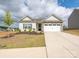 Charming single-story home with a stone-accented facade and a manicured front yard at 105 Tanner Loop, Troutman, NC 28166