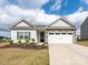 Charming single-Gathering home with stone accents, two-car garage, landscaping, and inviting curb appeal at 105 Tanner Loop, Troutman, NC 28166