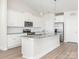 Modern kitchen featuring white cabinets, stainless steel appliances, and granite countertops at 105 Tanner Loop, Troutman, NC 28166