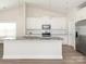 Kitchen with white cabinets, granite countertops, stainless steel appliances, and luxury vinyl floors at 105 Tanner Loop, Troutman, NC 28166
