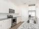 Kitchen featuring stainless appliances, granite counters, and white subway tile backsplash at 105 Tanner Loop, Troutman, NC 28166