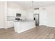 Bright kitchen features white cabinetry, granite countertops, and stainless-steel appliances at 105 Tanner Loop, Troutman, NC 28166