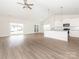 Open-concept living space with sliding glass doors, light fixtures and luxury vinyl flooring at 105 Tanner Loop, Troutman, NC 28166